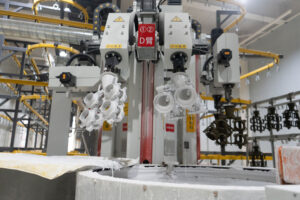 Robotic shell building line dipping wax assemblies in ceramic slurry
